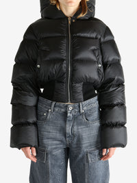 Black jacket worn by a person, showing the jacket fit