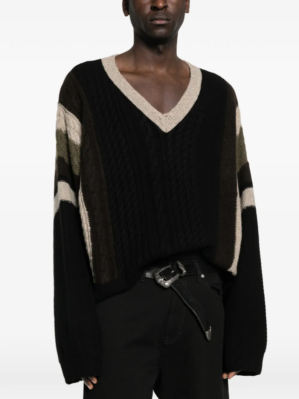 Black sweater worn by a person, showing the sweater fit