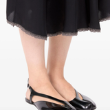 black sandals,worn by a person, showing the sandals fit