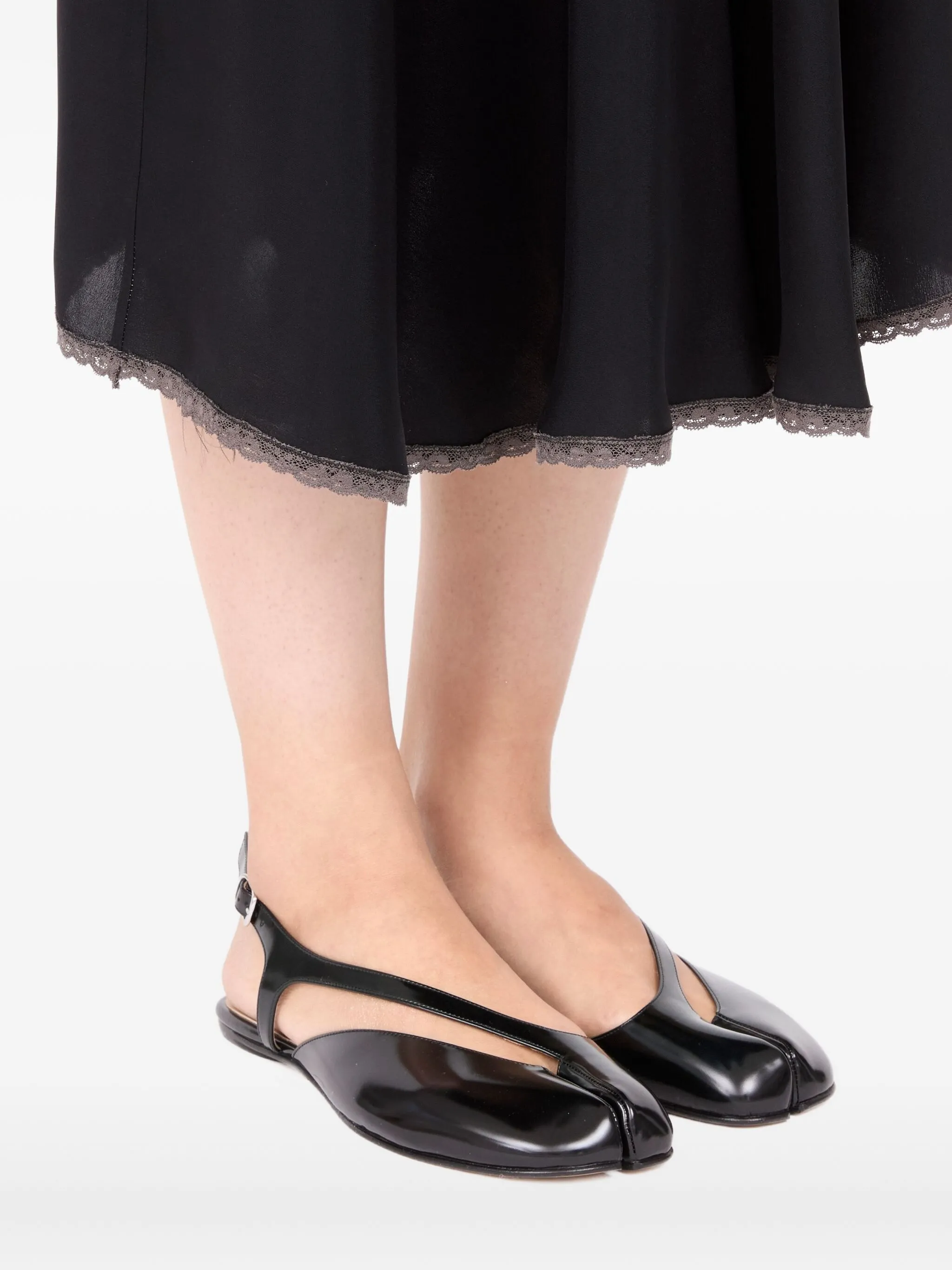 black sandals,worn by a person, showing the sandals fit
