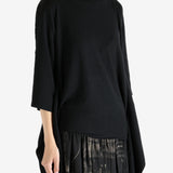 Black top worn by a person, showing the top's fit