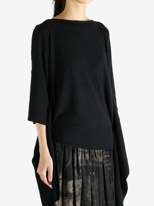 Black top worn by a person, showing the top's fit