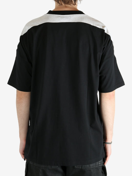 Black t-shirt worn by a person, showing the shirt's fit