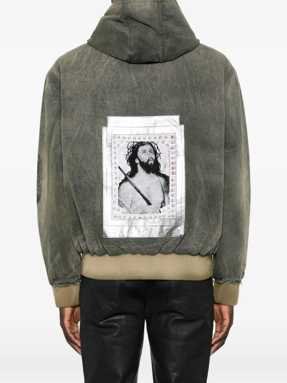 Green jacket worn by a person, showing the jacket fit