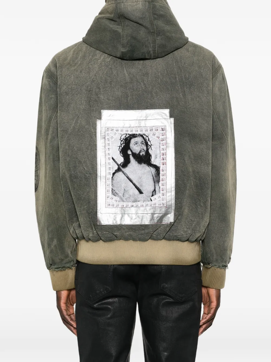 Green jacket worn by a person, showing the jacket fit