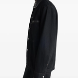 Black jacket worn by a person, showing the jacket's fit