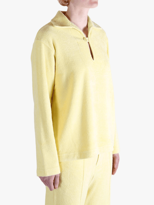 Yellow shirt worn by a person, showing the shirt's fit