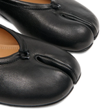 close up of black flats, showing texture of the leather fabric