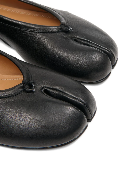 close up of black flats, showing texture of the leather fabric