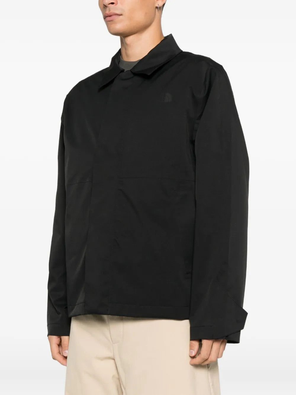 Black jacket worn by a person, showing the jacket fit