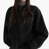 Black top worn by a person, showing the top fit