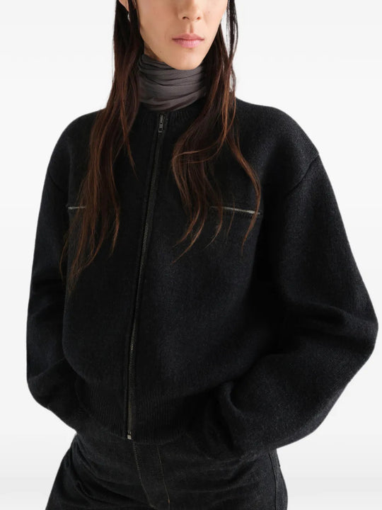 Black top worn by a person, showing the top fit