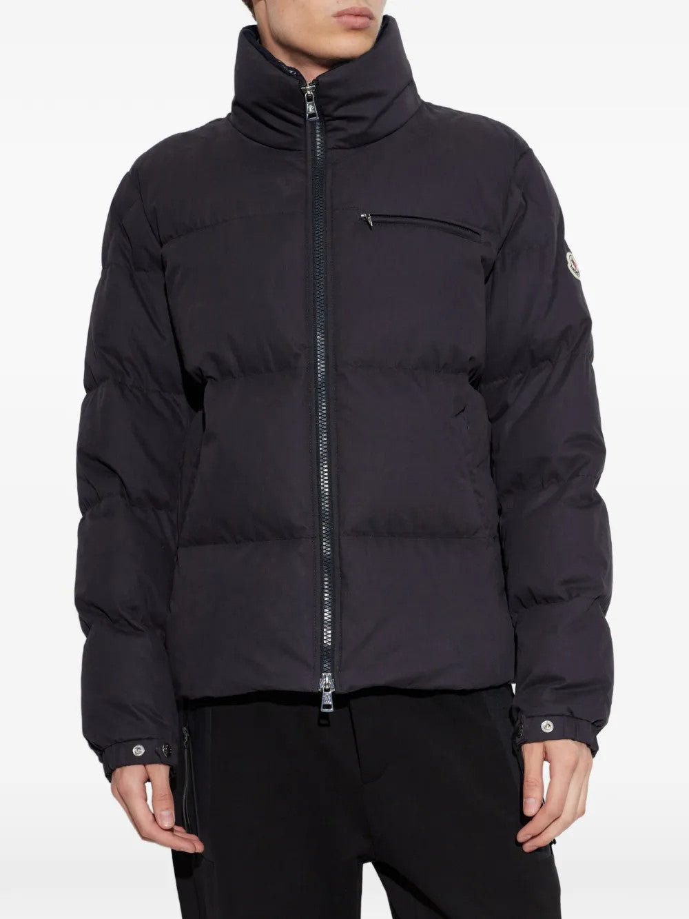 Black jacket worn by a person, showing the jacket fit