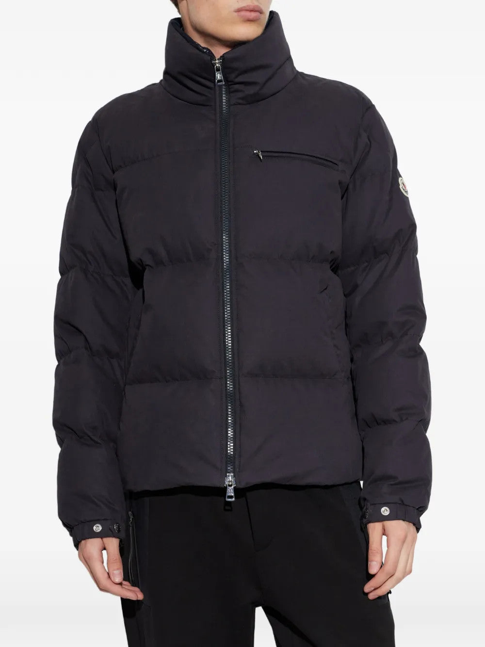 Black jacket worn by a person, showing the jacket fit