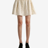 White skirt worn by a person, showing the skirt fit