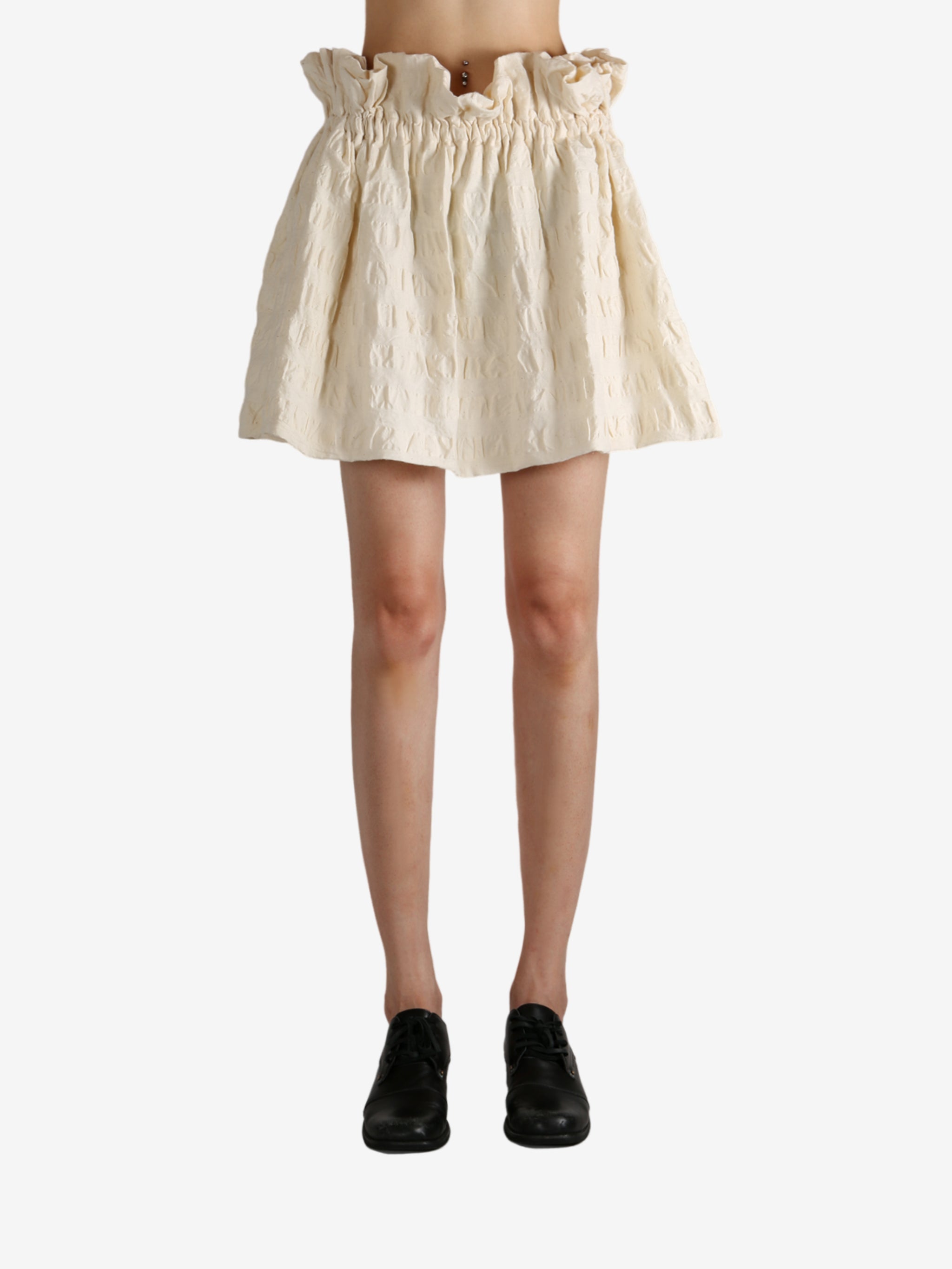 White skirt worn by a person, showing the skirt fit