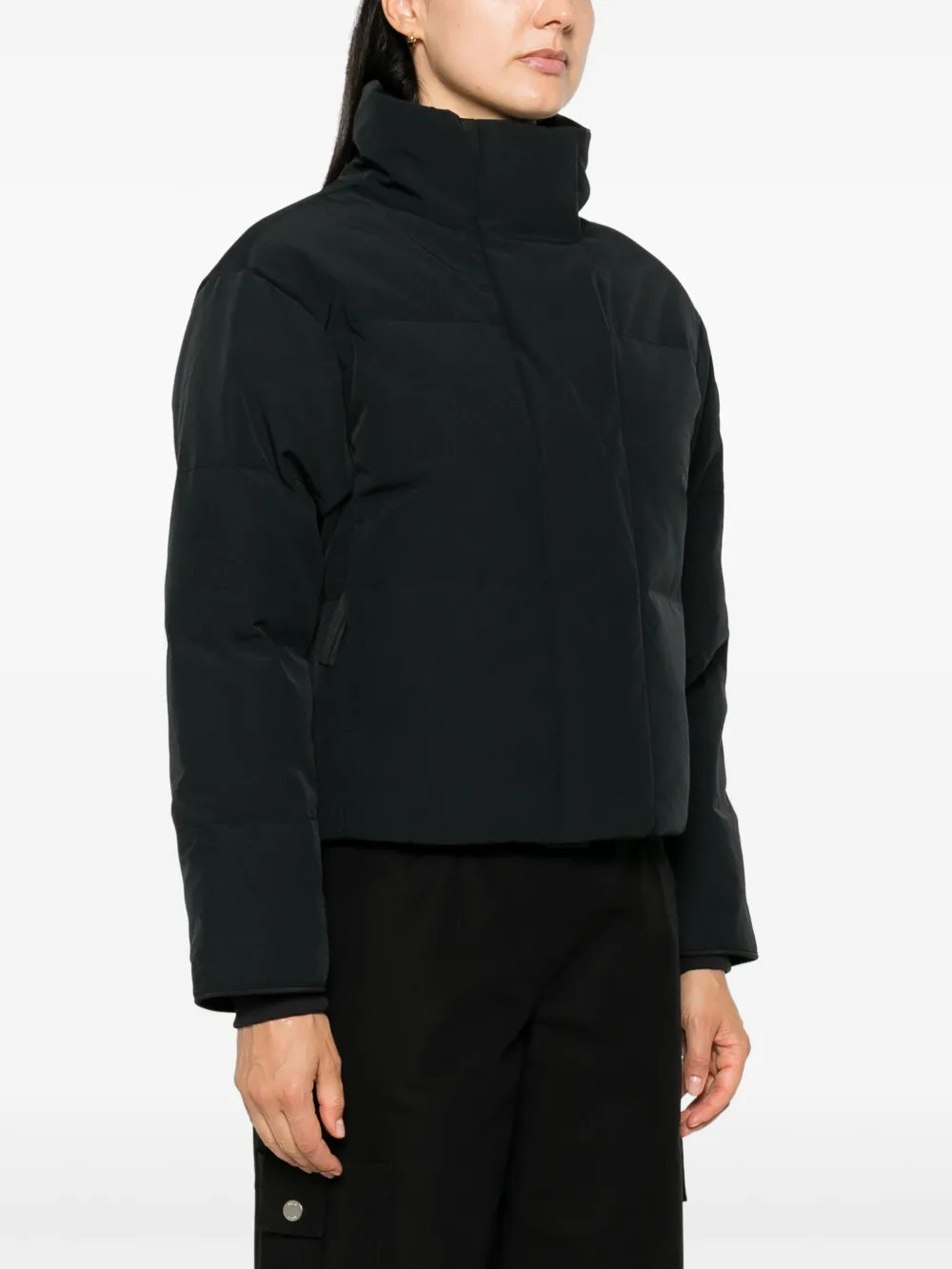 Black jacket worn by a person, showing the jacket fit
