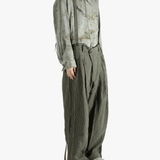Green pants worn by a person, showing the pants's fit