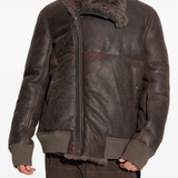 Brown jacket worn by a person, showing the jacket's fit