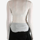 White top worn by a person, showing the top's fit