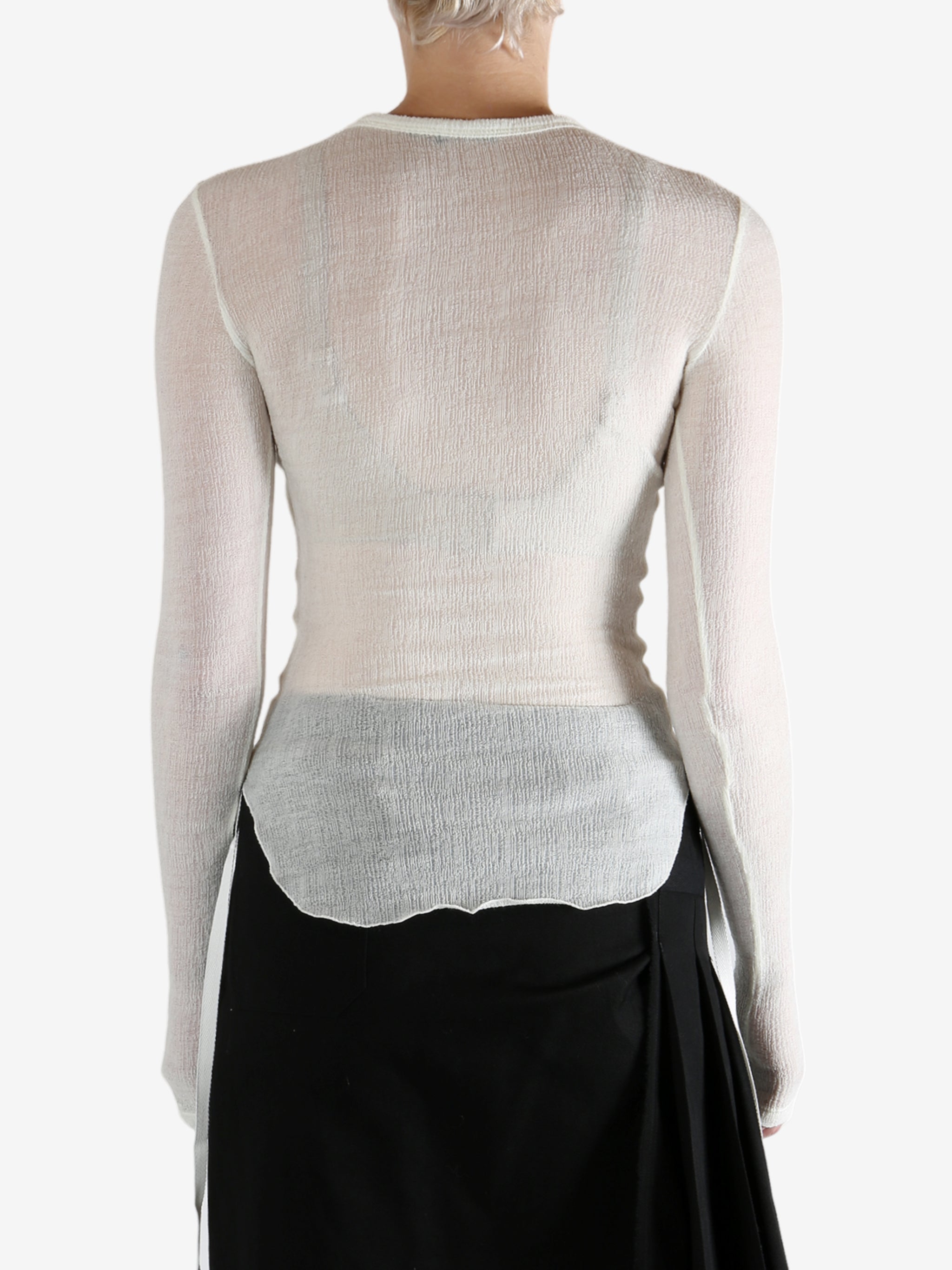 White top worn by a person, showing the top's fit