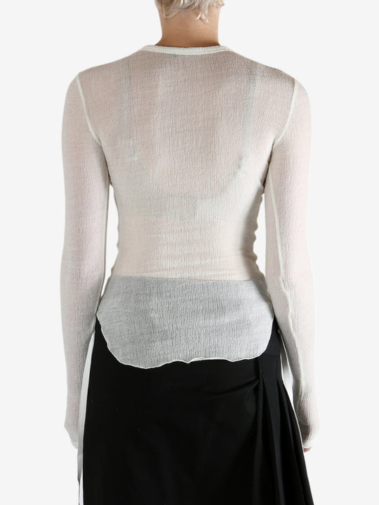 White top worn by a person, showing the top's fit