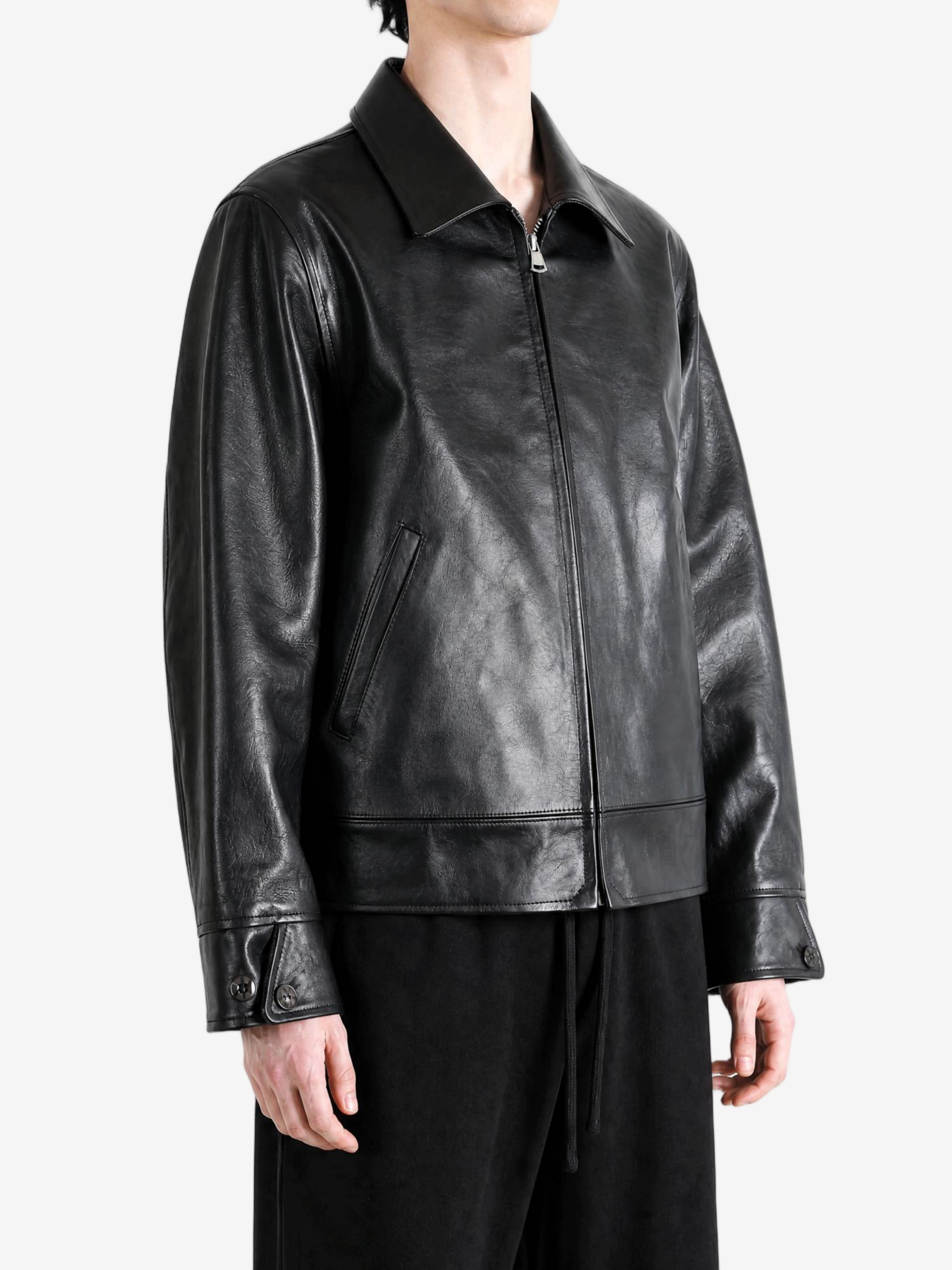 Black jacket worn by a person, showing the jacket fit