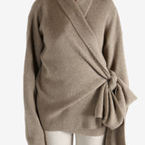 Tan cardigan worn by a person, showing the cardigan's fit