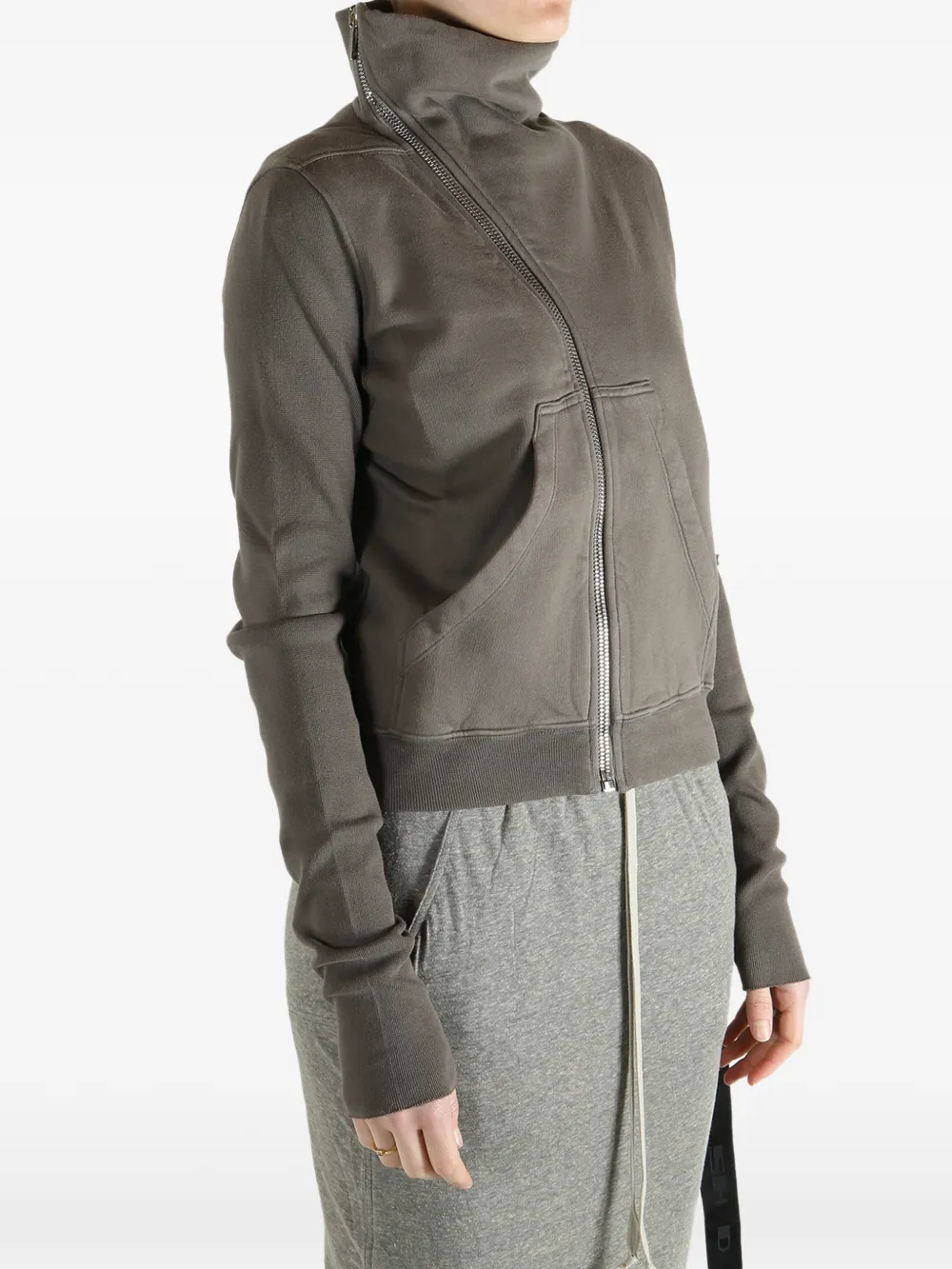 Grey sweat worn by a person, showing the sweat fit