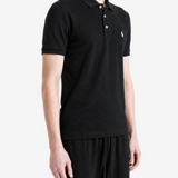 Black shirt worn by a person, showing the shirt fit