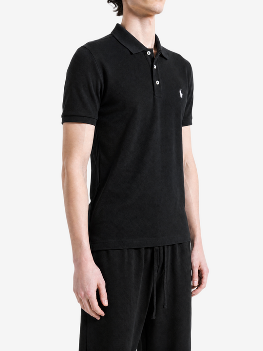 Black shirt worn by a person, showing the shirt fit