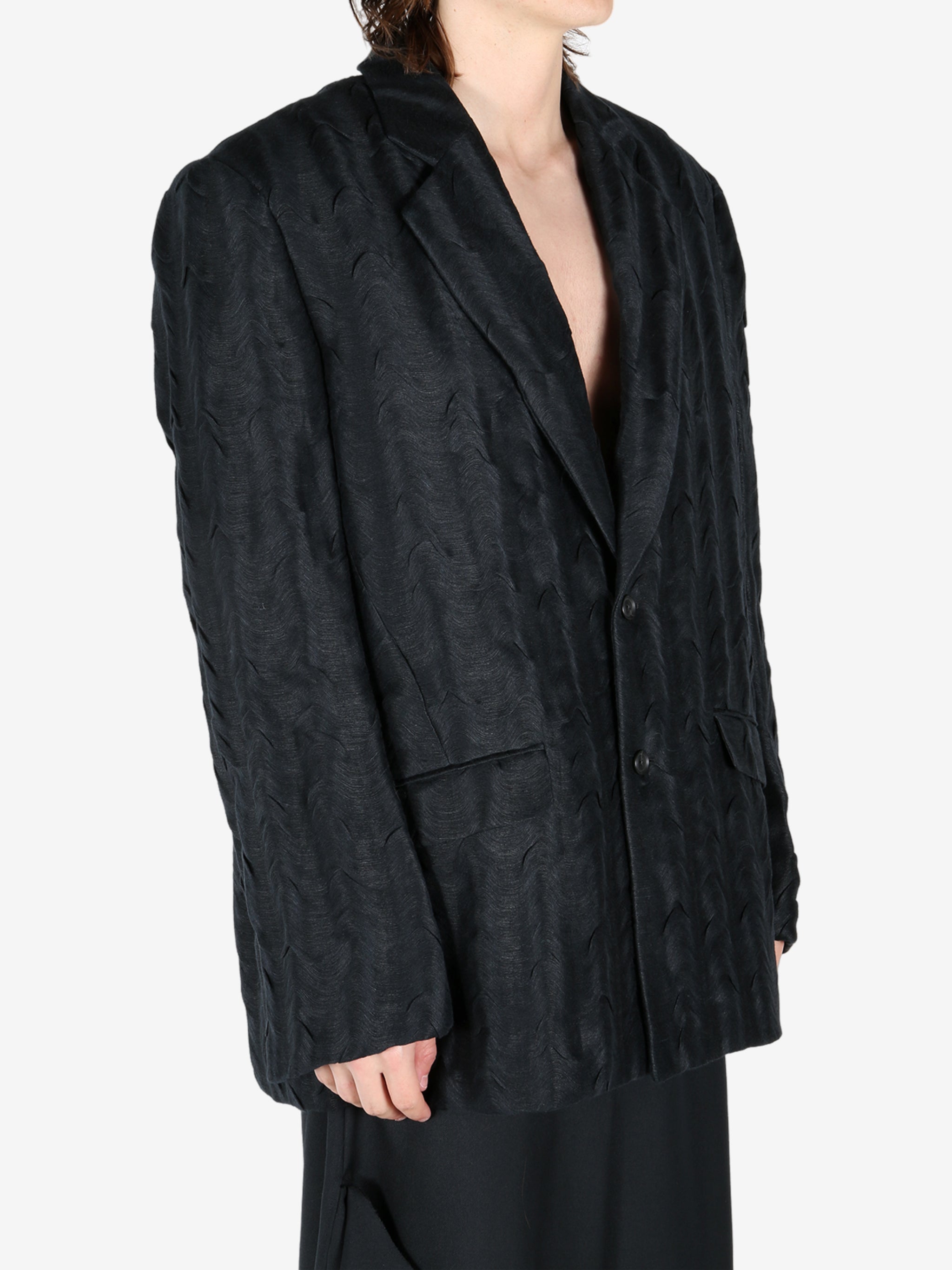 Black jacket worn by a person, showing the jacket's fit