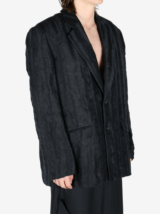 Black jacket worn by a person, showing the jacket's fit