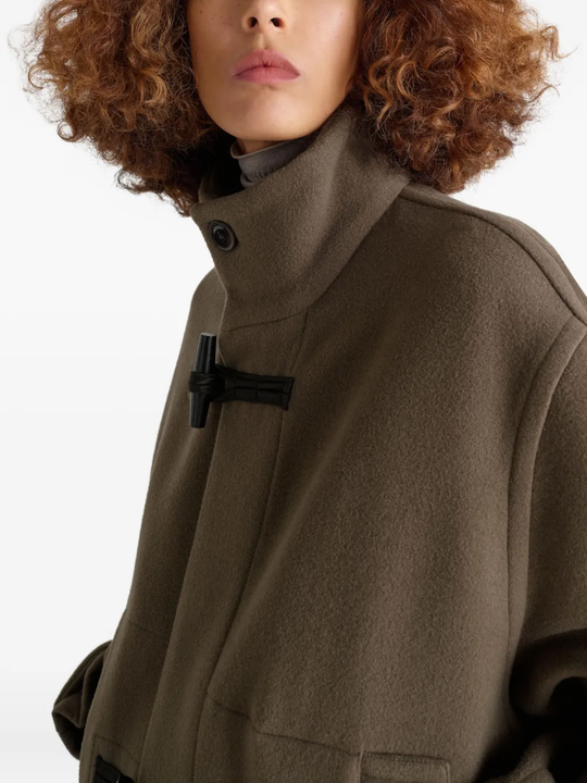 Close up of brown coats, showing texture of the cotton and wool fabric