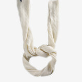 Close up of white scarves, showing texture of the cashmere and wool fabric