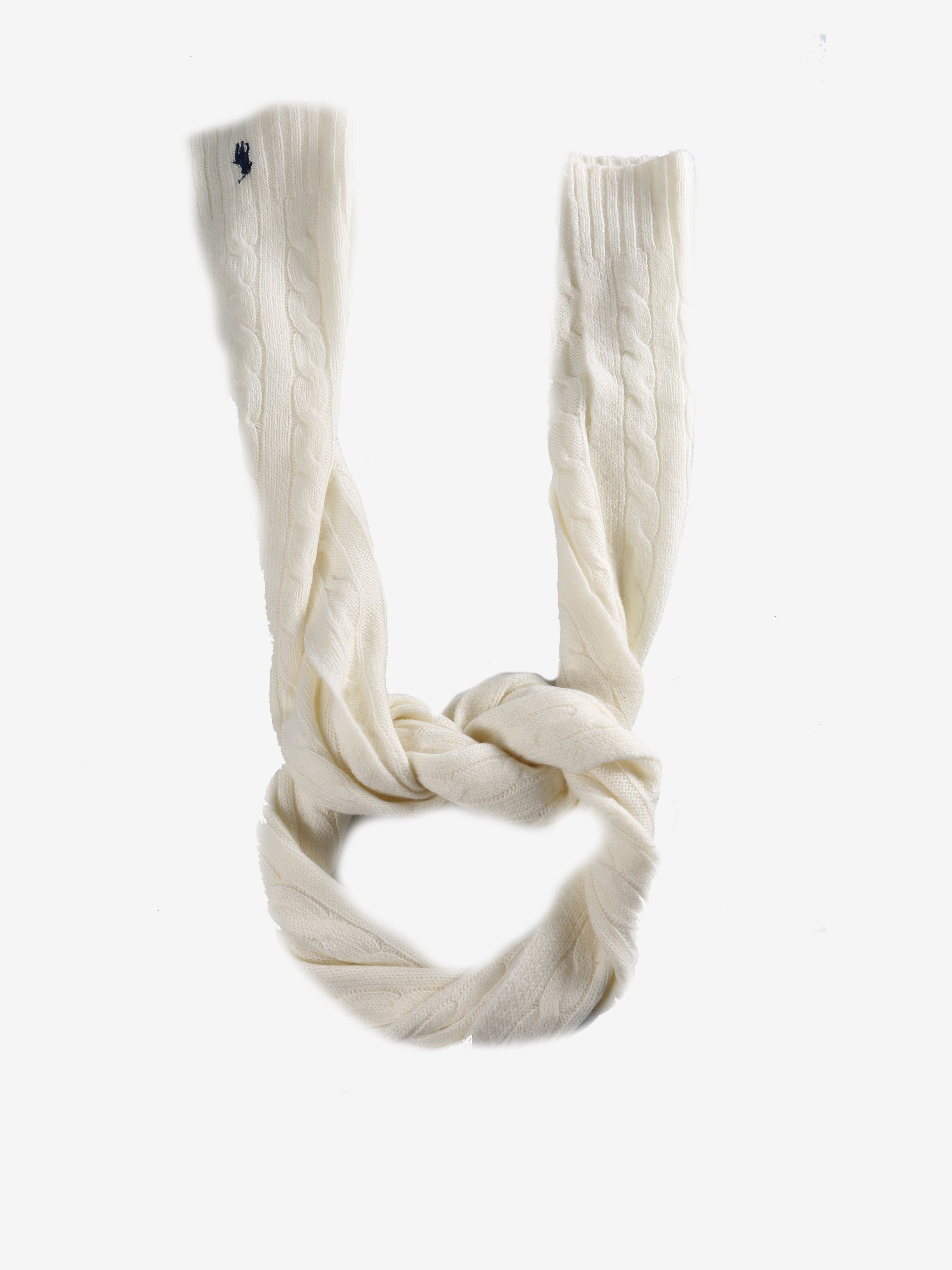 Close up of white scarves, showing texture of the cashmere and wool fabric