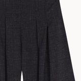 Close up of Black pants, showing texture of the 83% virgin wool/ 17% silk made in fabric