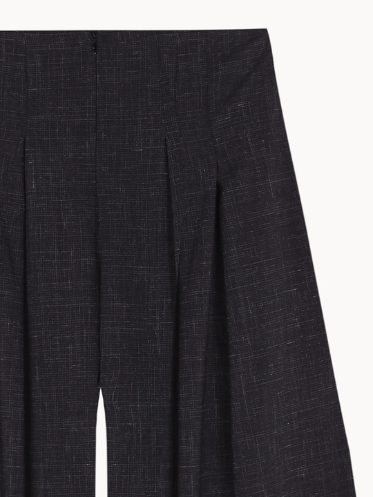 Close up of Black pants, showing texture of the 83% virgin wool/ 17% silk made in fabric