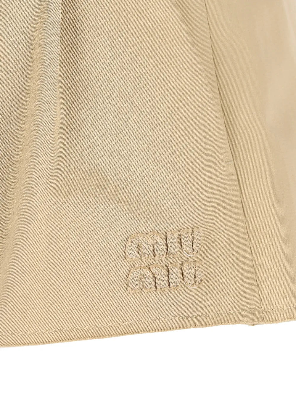 Close up of Tan skirt, showing texture of the 25% steel/ 50% zamak/ 25% brass/ 100% cotton fabric