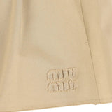 Close up of Tan skirt, showing texture of the 25% steel/ 50% zamak/ 25% brass/ 100% cotton fabric