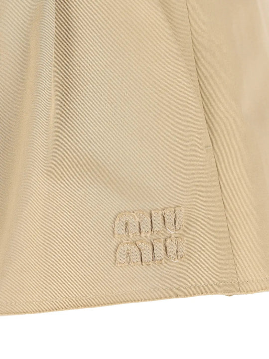 Close up of Tan skirt, showing texture of the 25% steel/ 50% zamak/ 25% brass/ 100% cotton fabric