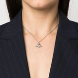 White pendant worn by a person, showing the pendant's fit