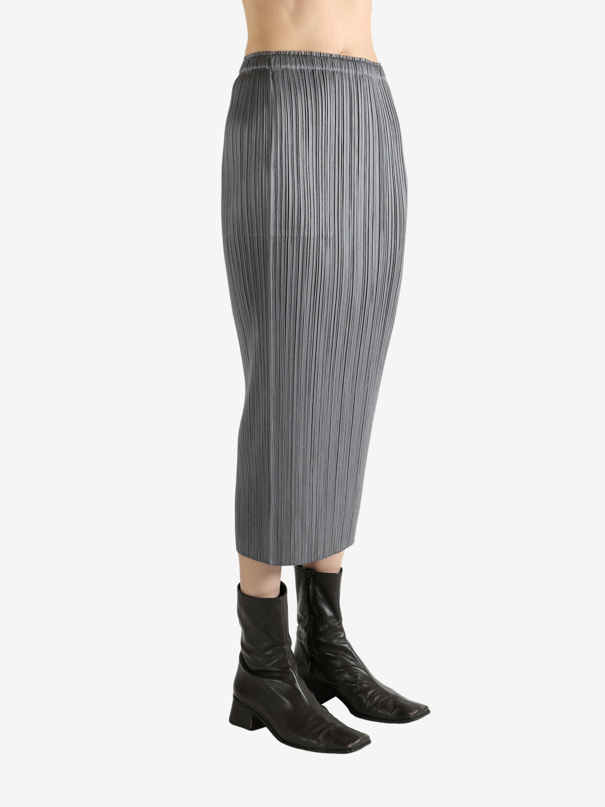 Grey skirts worn by a person, showing the skirts fit