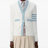 White cardigan worn by a person, showing the cardigan fit