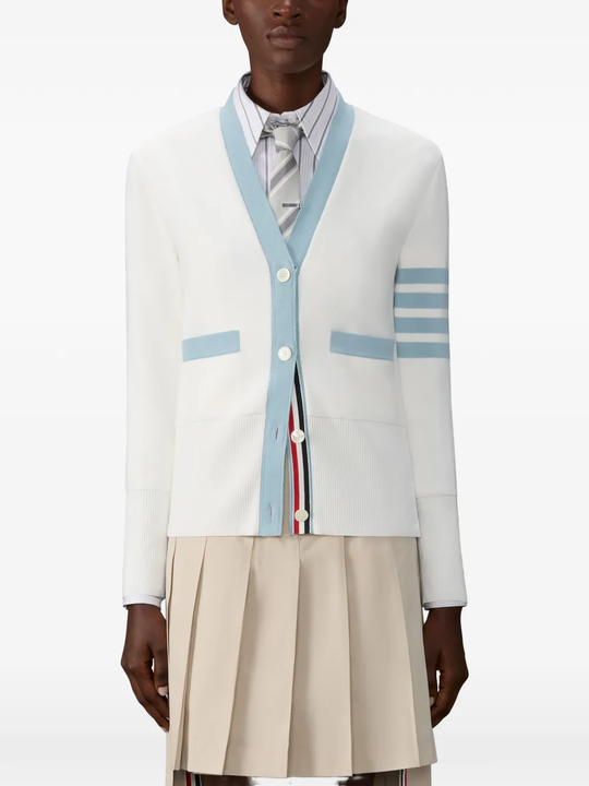 White cardigan worn by a person, showing the cardigan fit