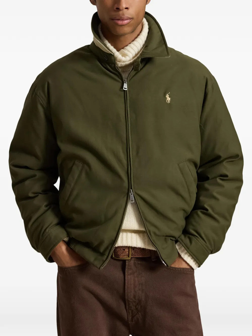 Green jacket worn by a person, showing the jacket fit