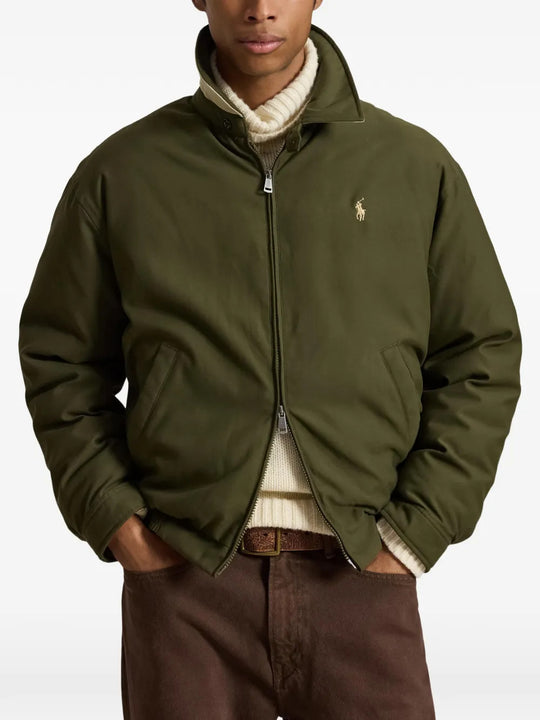 Green jacket worn by a person, showing the jacket fit