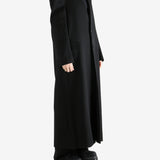 Black coats worn by a person, showing the coats fit