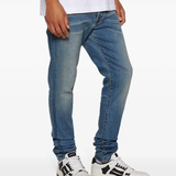 White sneaker worn by a person, showing the sneaker's fit