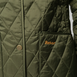 Close up of green jackets, showing texture of the polyester and cotton fabric